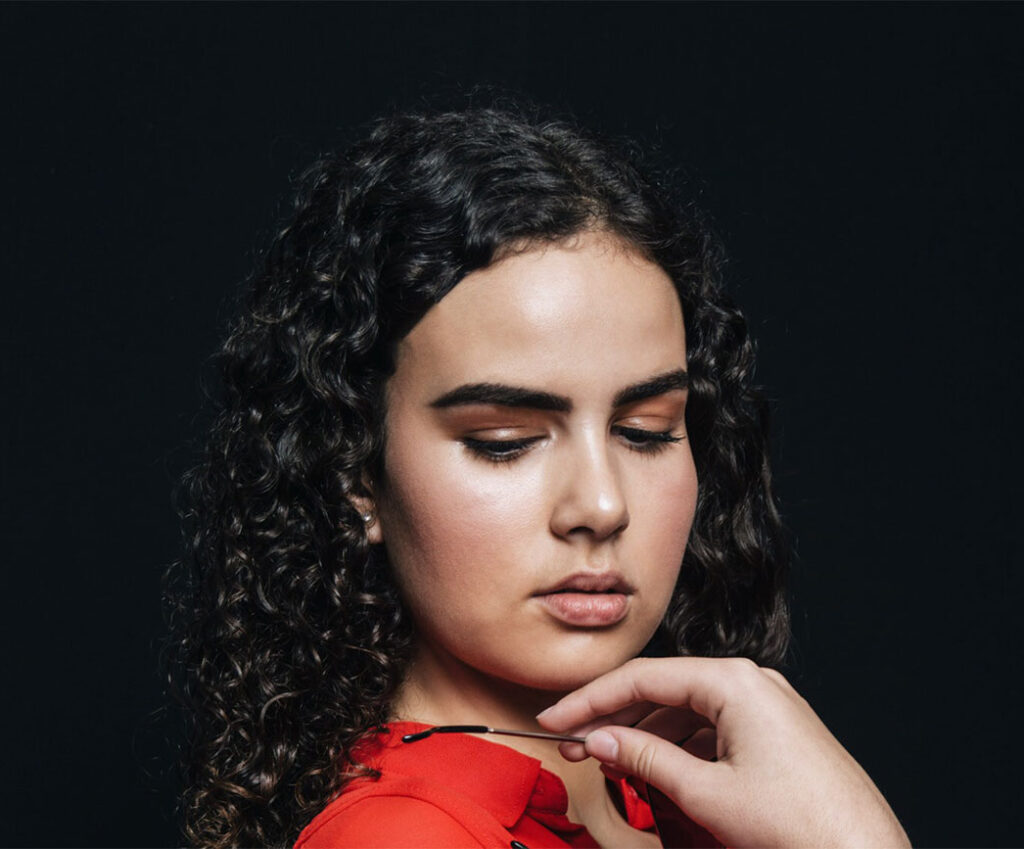 Young woman posing thoughtfully while considering abortion and pregnancy counseling PRC Grand Rapids.