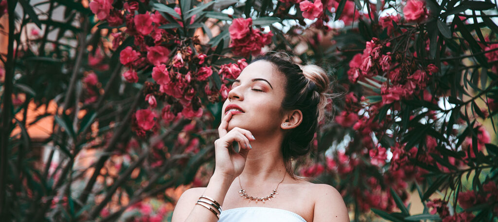 Woman resting her chin on her hand while processing pregnancy emotions PRC Grand Rapids.