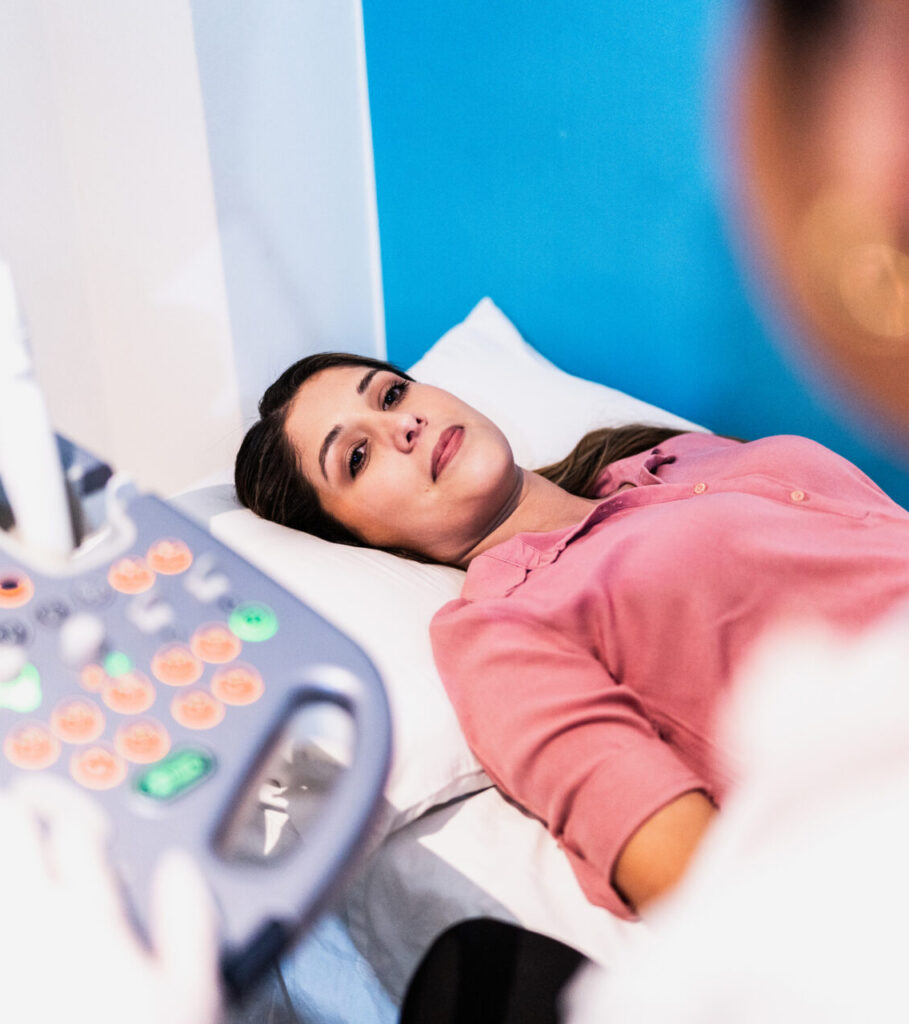 Woman lying comfortably during an ultrasound appointment at a pregnancy support center.