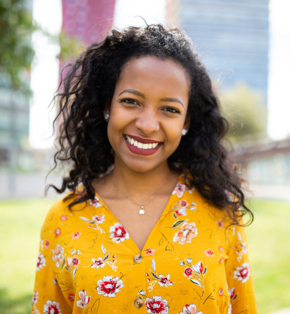 Woman smiling brightly while feeling encouraged through pregnancy support services.