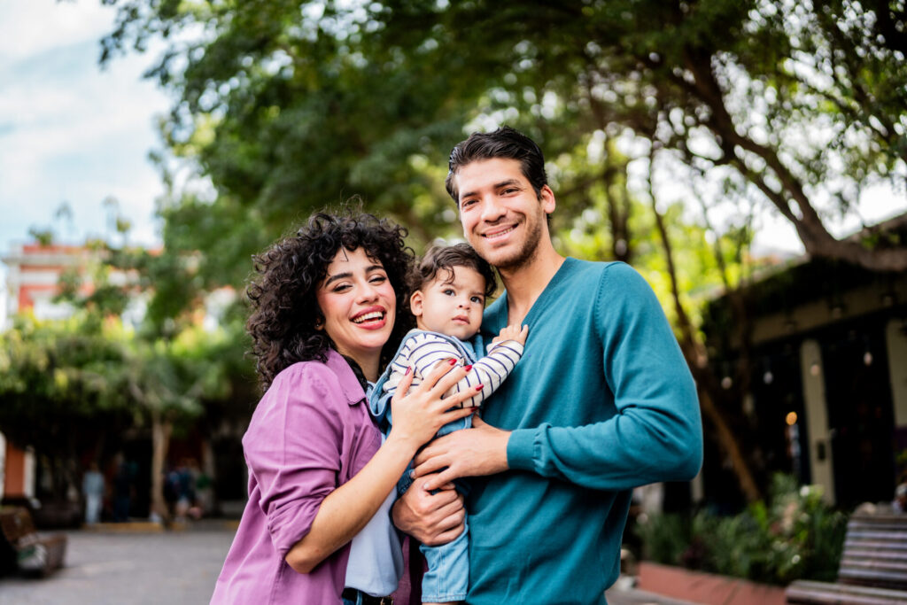 Couple holding their baby while receiving family and parenting support from PRC Grand Rapids.