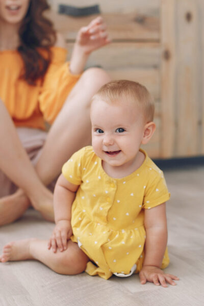 Cute little girl with mother. Family at home in a kitchen
